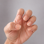 hand with nude nail polis