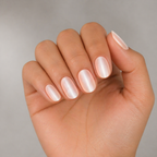 Hand with light pink nail polish on a neutral background